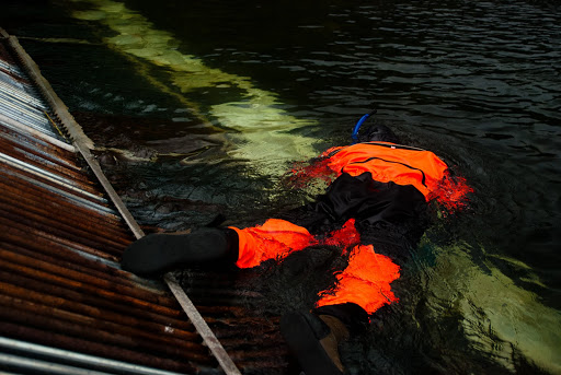 Not a corpse - just Joe in a drysuit, snorkeling along the weir and checking the sandbags.